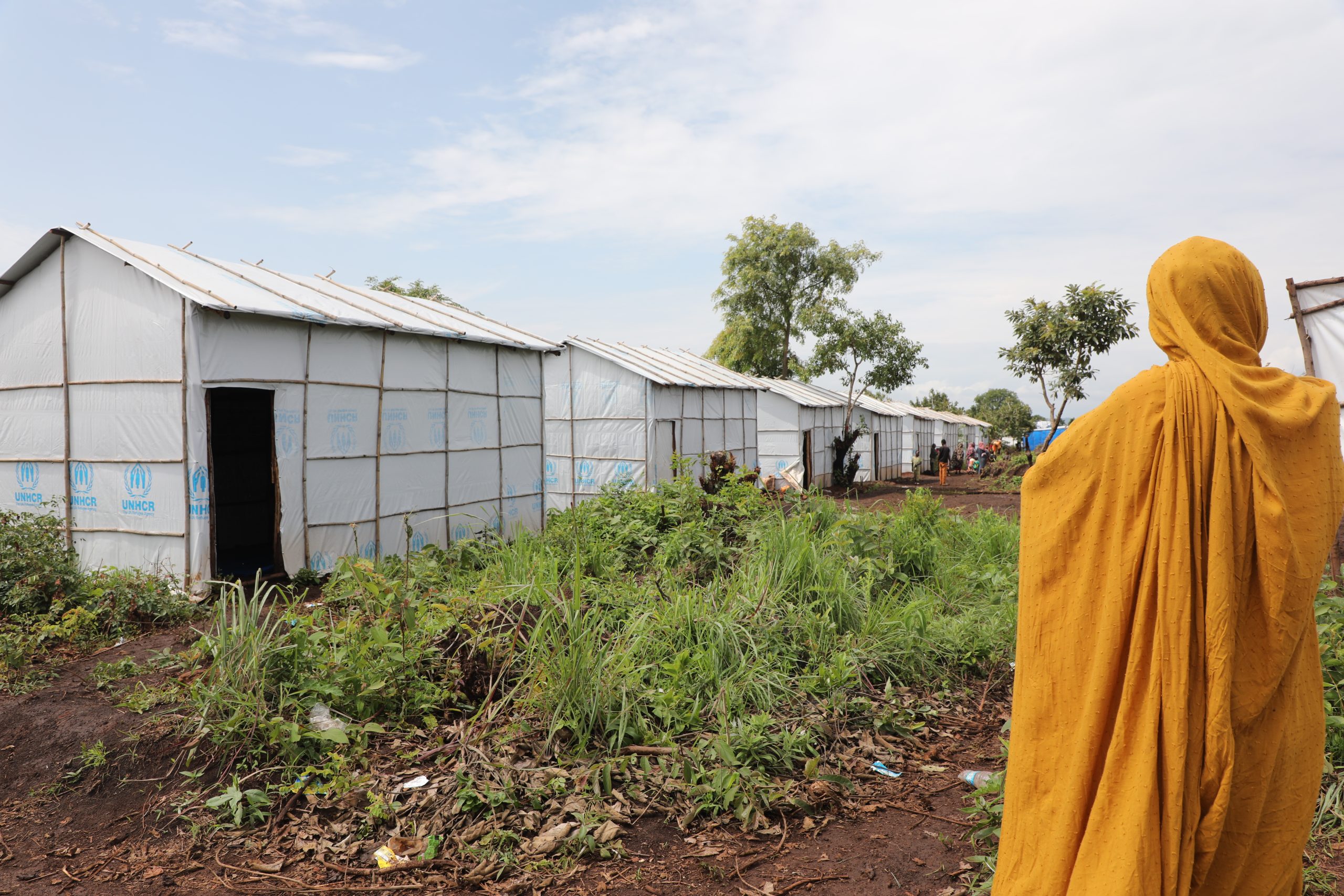 A Sudanese refugee woman observes the Ura settlement in Ethiopia, where refugees and host communities have lived side by side under a shared support system since 2024.
